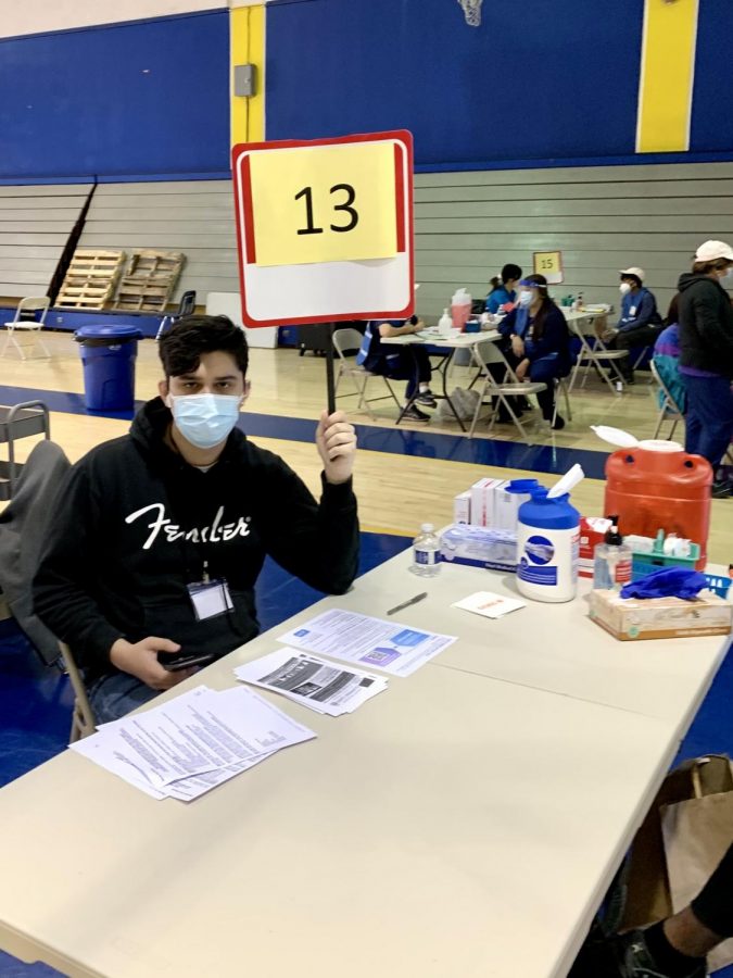 Senior Luka Price volunteers at a vaccine clinic.