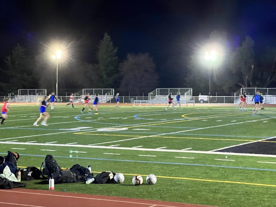 Girls’ varsity soccer team practices with new lights on.