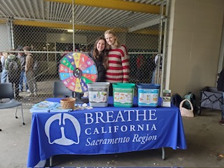 Food waste project organizers Genevieve Ferrera and Emilie Thoreson hold a fundraiser.