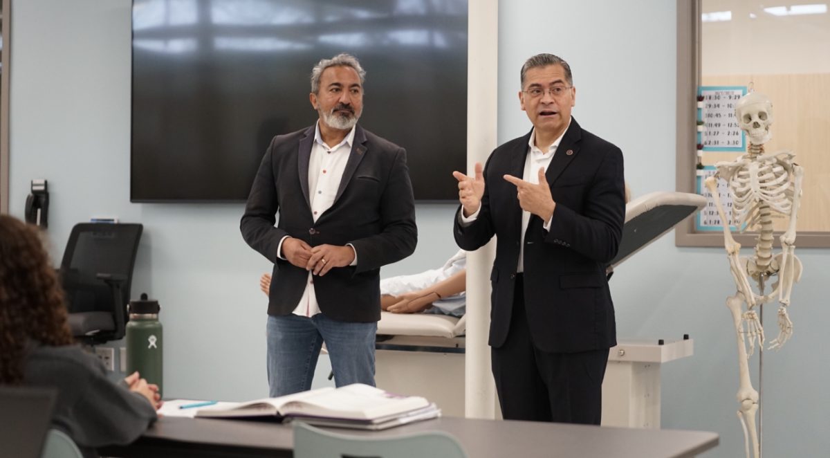 U.S. Rep Ami Bera (left) and Health and Human Services Secretary Xavier Becerra (right) speak to students in the medical careers facility.