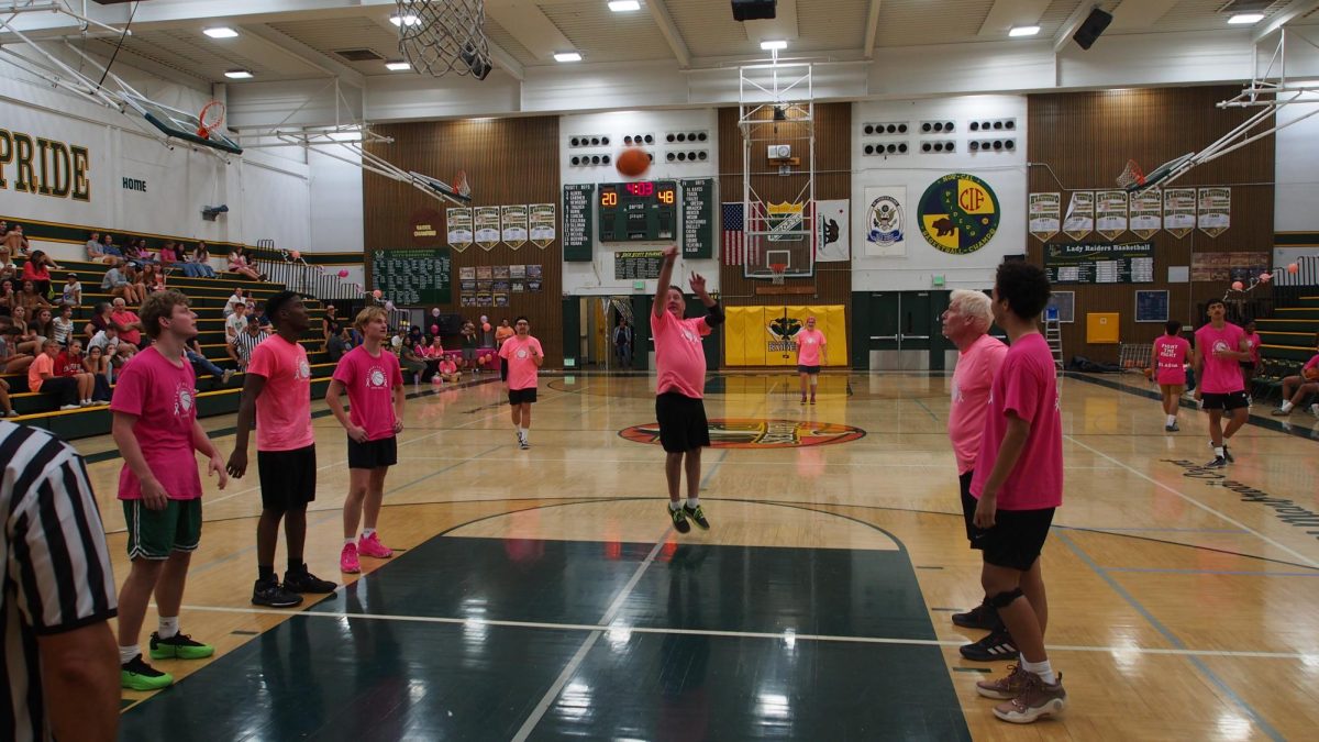 Students and teachers face off in the annual Student vs. Staff basketball game on Oct. 10. Proceeds from the ticket sales go to breast cancer awareness.