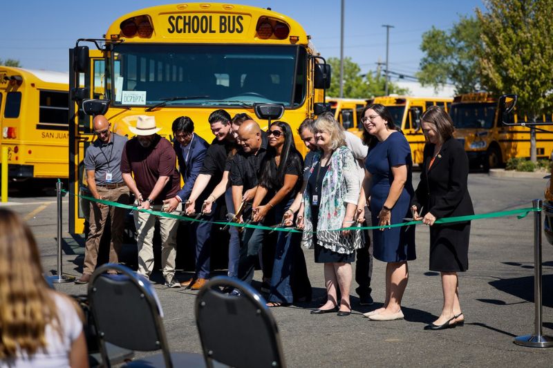 San Juan Unified School District leaders celebrate the new electric school buses at a July event. Photo from the district.