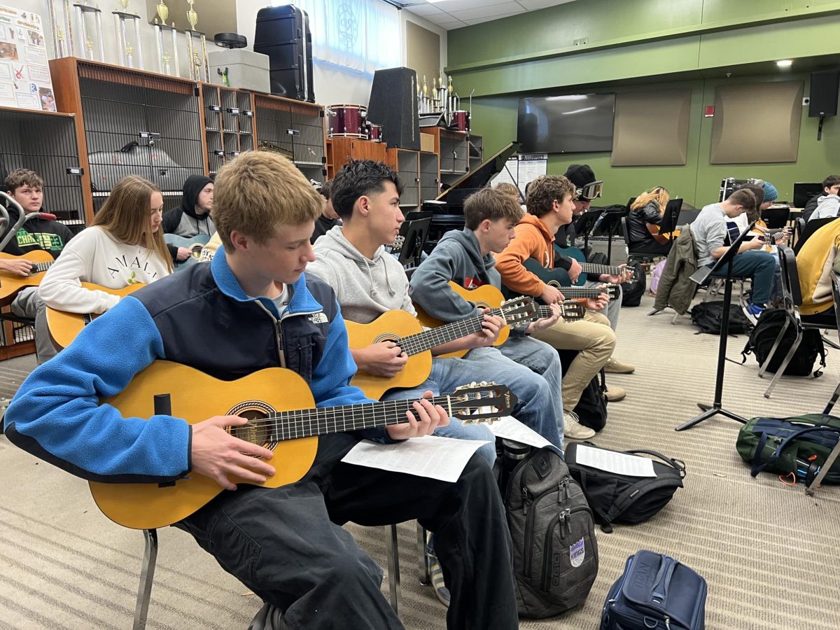 Students practice in Victor San Pedro's newly created guitar class.