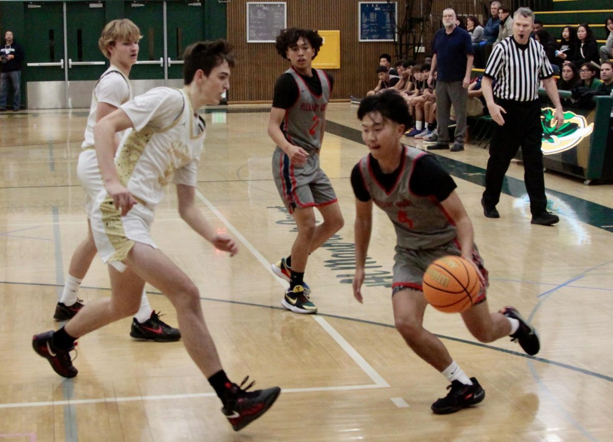 Jared Mikacich (11) guards against Pleasant Grove in a preseason game in November, 2024.