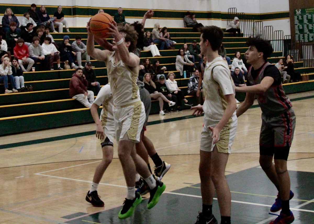 Jase Thompson (12) gets a rebound against Pleasant Grove in a preseason game in November 2024.