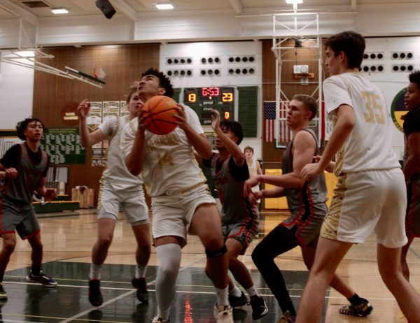 Max Harry (12) drives to the basket against Pleasant Grove in a preseason game in November 2024.