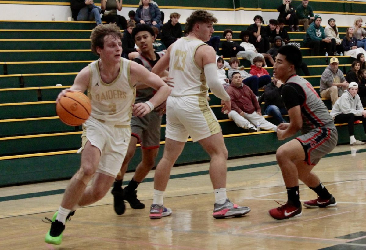 Jace Thompson (12) drives to the basket against Pleasant Grove in a preseason game in November 2024.