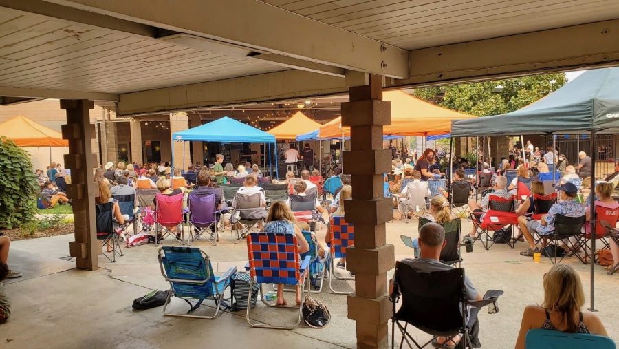 Arcade Church has returned to in-person worship services in the church's courtyard. Church members bring their own seating, sit socially distanced from each other, and wear masks to keep everyone safe. 