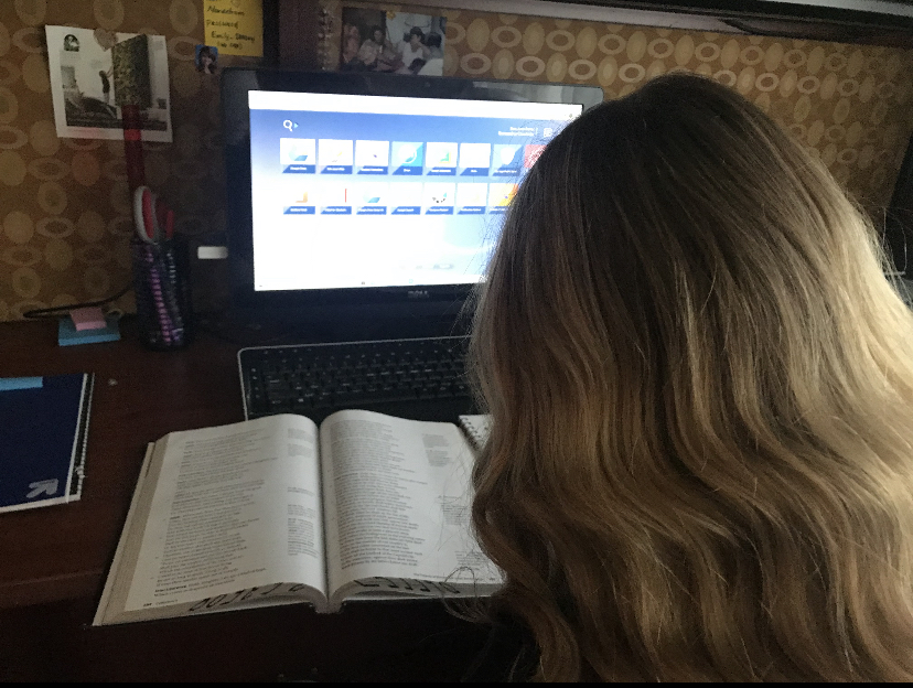 During the third week of school, freshman Samantha Courtade takes notes on The Odyssey from her English book as she logs into the San Juan Portal, where she will be able to turn in her work virtually. 