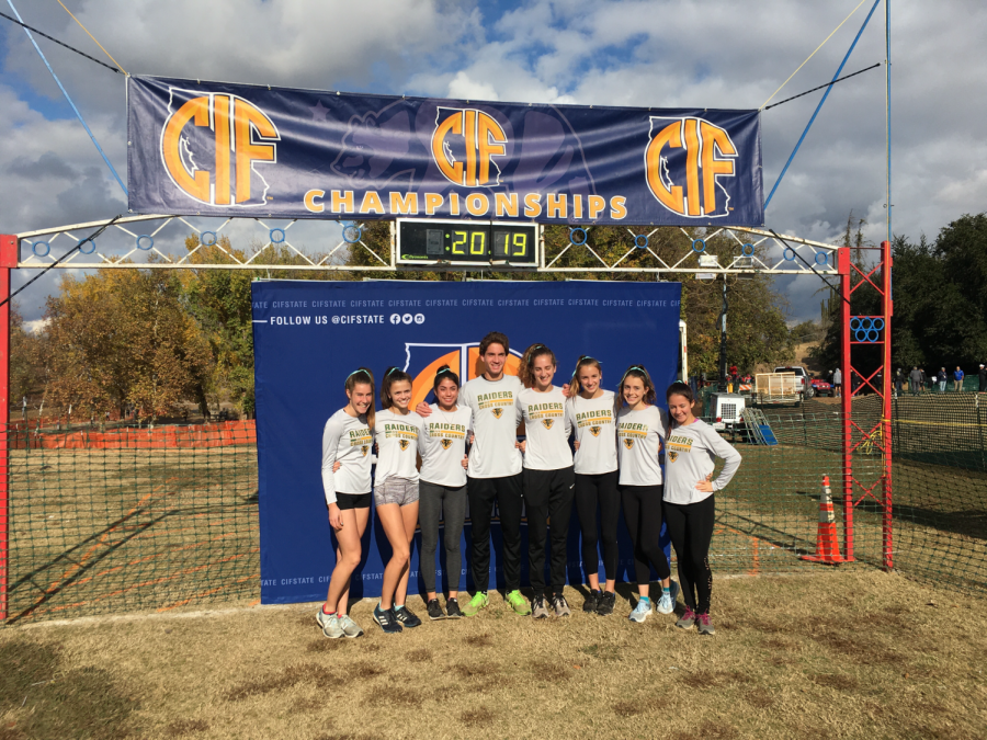 [left to right] Katie Newton, Lucy Prieto, Alyssa Escay, Nicolas Gorman, Annalee Gorman, Olivia Schlieman, Kaylee Barnes, and Ava Cardwell pose at the Calif. Cross Country State Championship Meet.