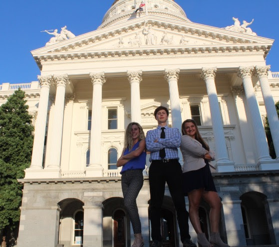 Civitas seniors (from left to right) Samantha Ford, Jacob Osecheck, and Carolyn Lidster posing in front of the state capitol.