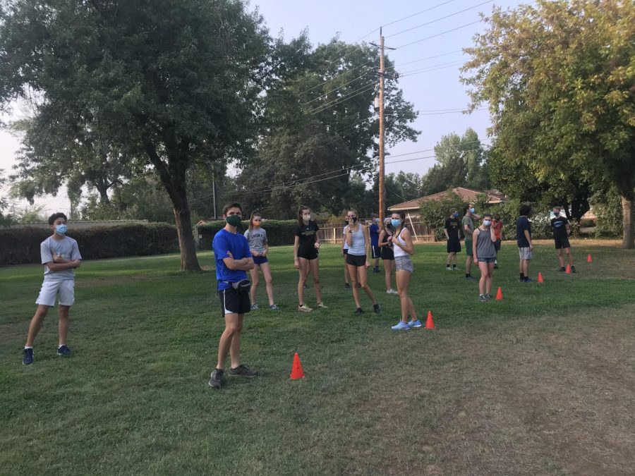 The cross country team has kept conditioning safe with small training groups, temperature checks, and mandatory masking for all runners. 