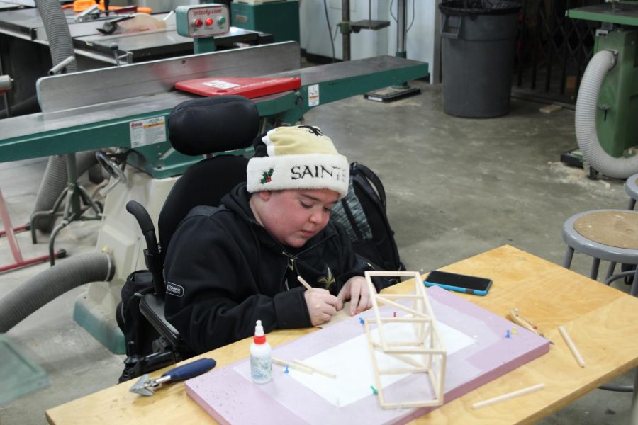 Nathaniel St. Geme works on a bridge project in his engineering class. St. Geme says the Americans with Diasabilitues Act, which was signed into law by President George H. W. Bush, who died last month, has greatly helped his education. Photo by Alex Lydon.