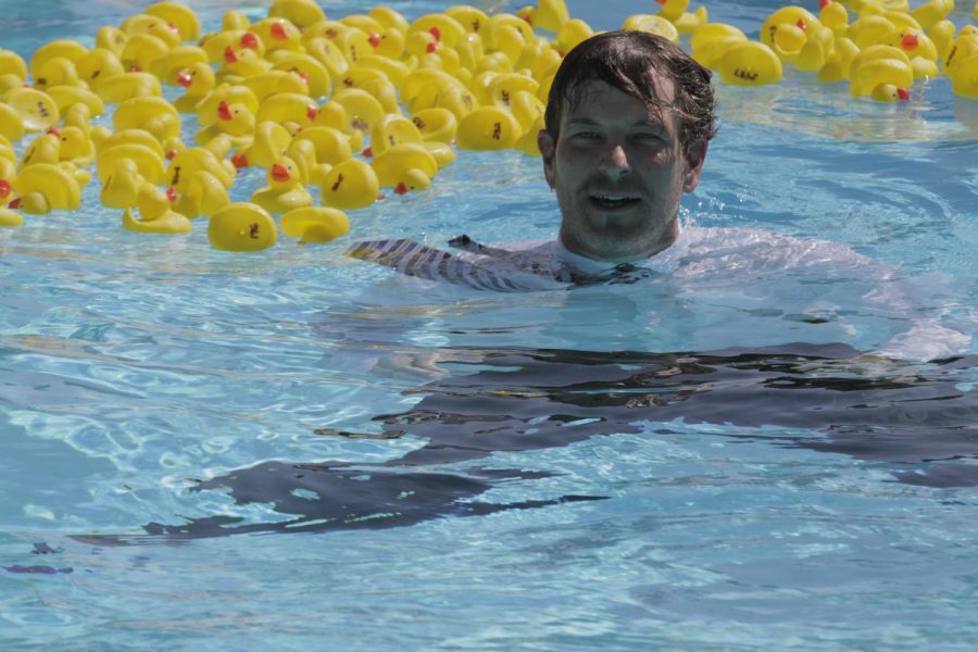 Principal Brian Ginter fishes prize-winners out of the pool on  Sept. 22 for the Duck Derby fundraiser that raised $16,008 for the school.