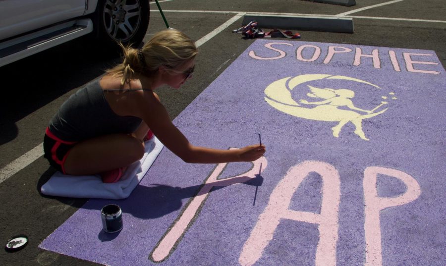 Senior Sophie Papanto- niadis paints her name on her parking spot with a fairy. Her love for fair- ies as a kid inspired her design.