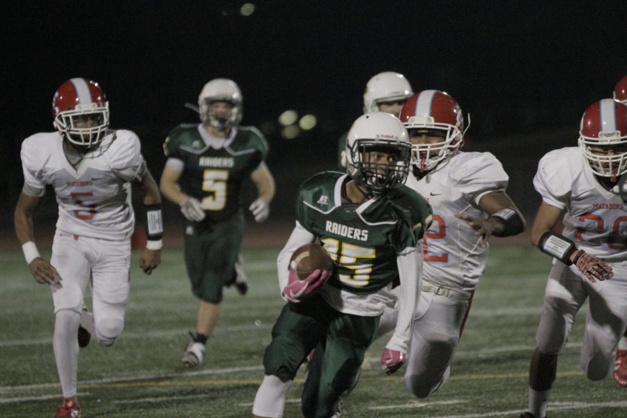 Sophomore Savion Ponce carries the football in a game against Mira Loma on Oct. 27.