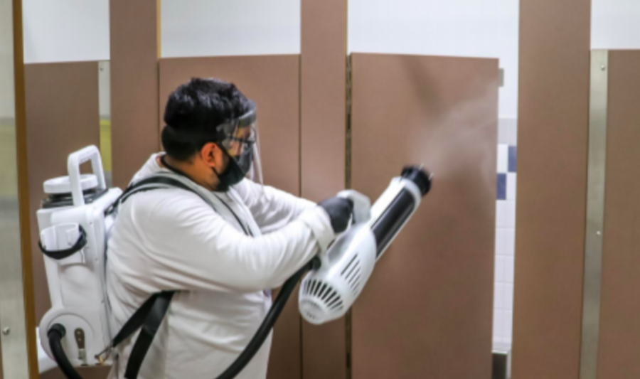 A worker sanitizes a restroom at Mira Loma High School in a photo that was included in the slide presentation shown to the school board on Oct. 13. Enhanced cleanings would be part of bringing students back on campus part-time. 