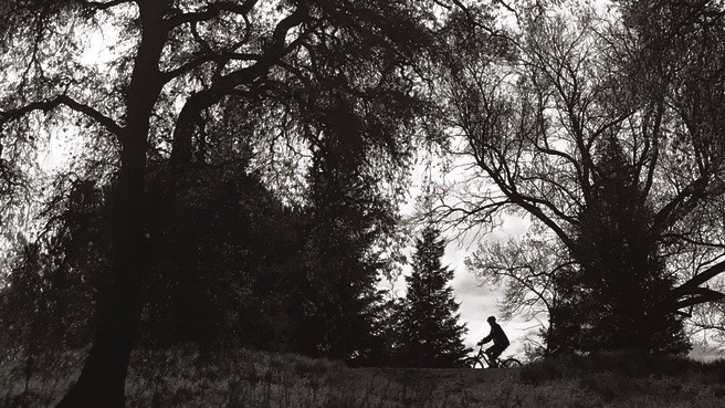 A bike rider enjoys a sunny day in April.