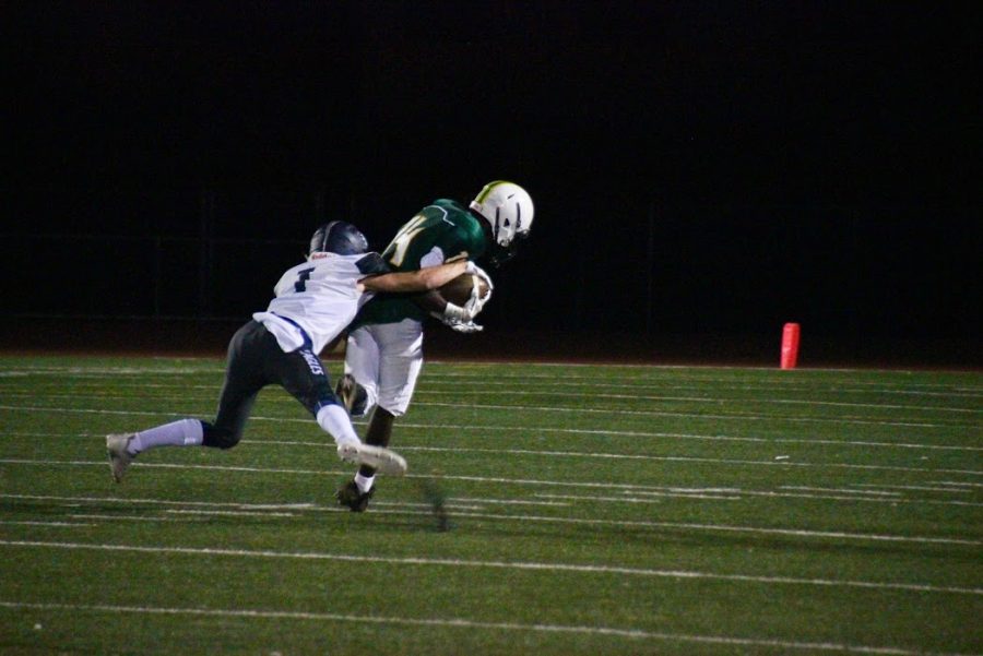 Jalen Taylor gets tackled after a long run.  Photo by Jane Snider.